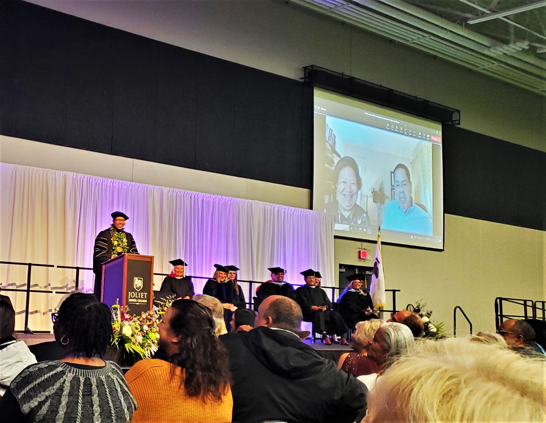 Dr. Clyne Namuo, Joliet Junior College's 10th President, is clearly surprised to enjoy a livestream from his parents in Hawaii during his November 15 investiture.