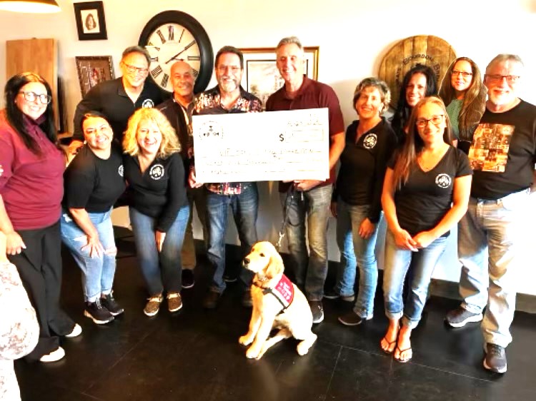 Brats, Bourbon, and Brews, a 501(c)(3) organization, recently donated $25,000 to the VIP Service Dog Foundation to supply veterans with six trained service dogs. Pictured are, front row, from left, Jenn Hillery (VIP Service Dogs), Amber Duffy, (committee member), Linda Slabaugh, (BBB Board Member), Walnut (Puppy in Training), Angie Aegerter (BBB Vice President). Back row, from left, John Simpson (BBB Board Member), Jeff Pierson (BBB Board Member), Tom Grotovsky (BBB Founder), Tom Bolek (VIP Service Dogs), Jen Lynch (BBB Board Member), Marlena Jurek (Committee Member), Sally Matay (BBB Board Member) and Clay Johnson (BBB Board Member). (Photo provided)