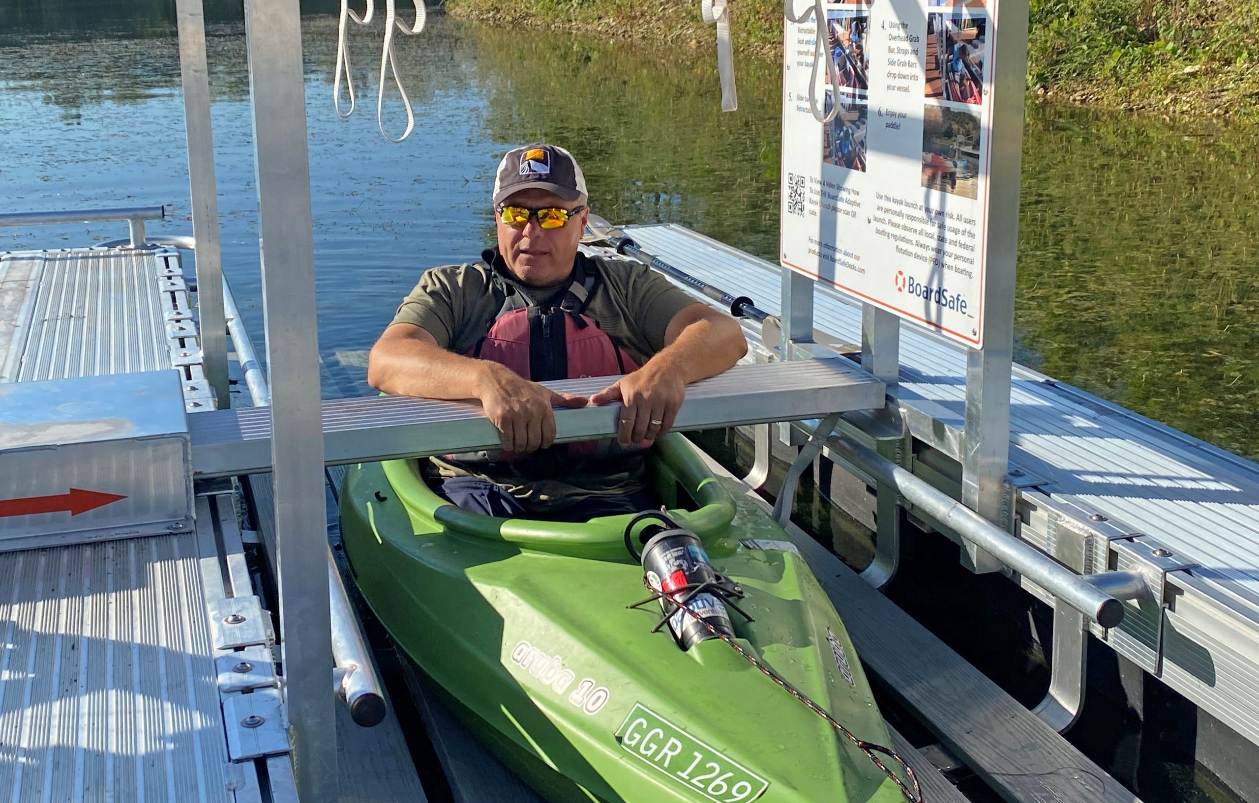 Bill Bogdan of Mokena tests out the new kayak/canoe launch at Lake Chaminwood Preserve near Channahon. The accessible device was installed recently by the Forest Preserve District of Will County to help people of all abilities enter and exit the water independently.(Photo by Forest Preserve staff | Cindy Cain and Chad Merda)