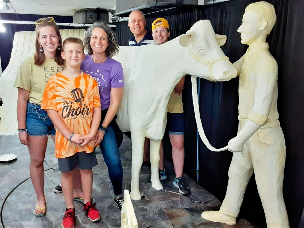 The Pratt family (from left), Hannah, Dean, Sarah, Andy and Grace, pose with a past state fair butter cow sculpture. (Photo courtesy of Sarah Pratt)