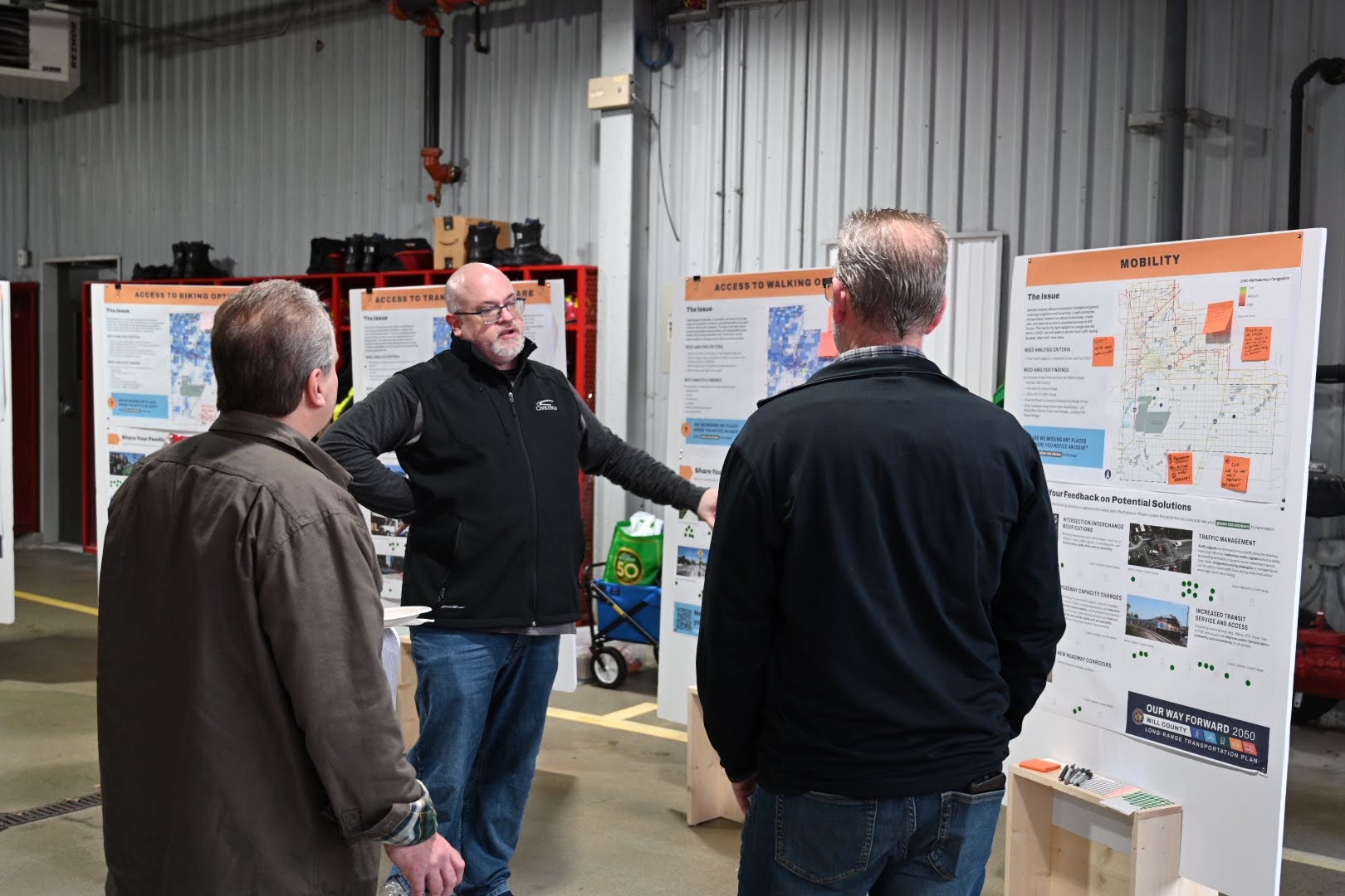 CivilTech’s Brian DeSalle reviews maps with Manhattan Township resident John Kieken and Manhattan Trustee Ron Adamski. (Photos by Stephanie Irvine)