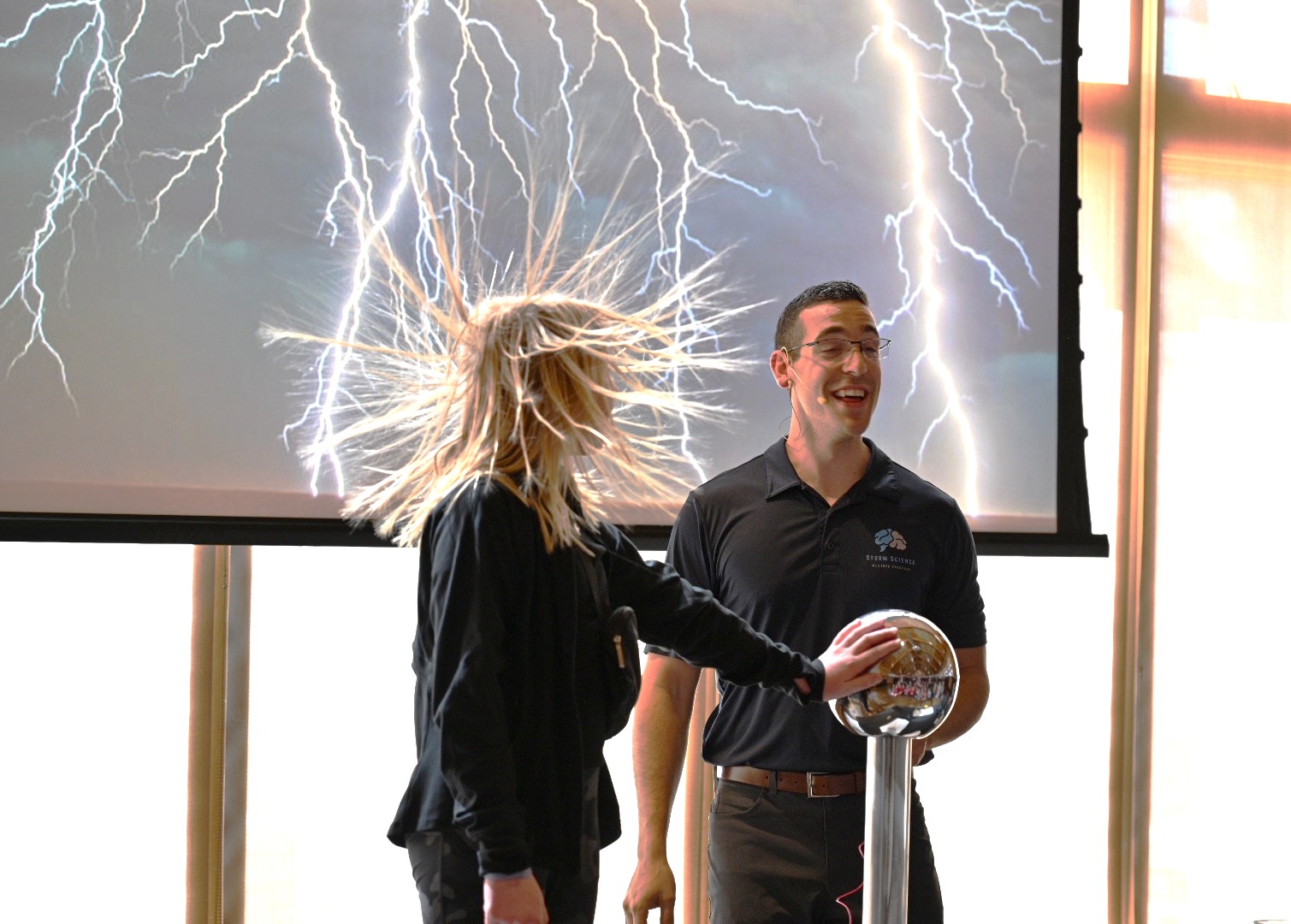 Madison Matichak, 11, of Channahon, experiences the power of electricity during a demonstration.(Photo by Stephanie Irvine)