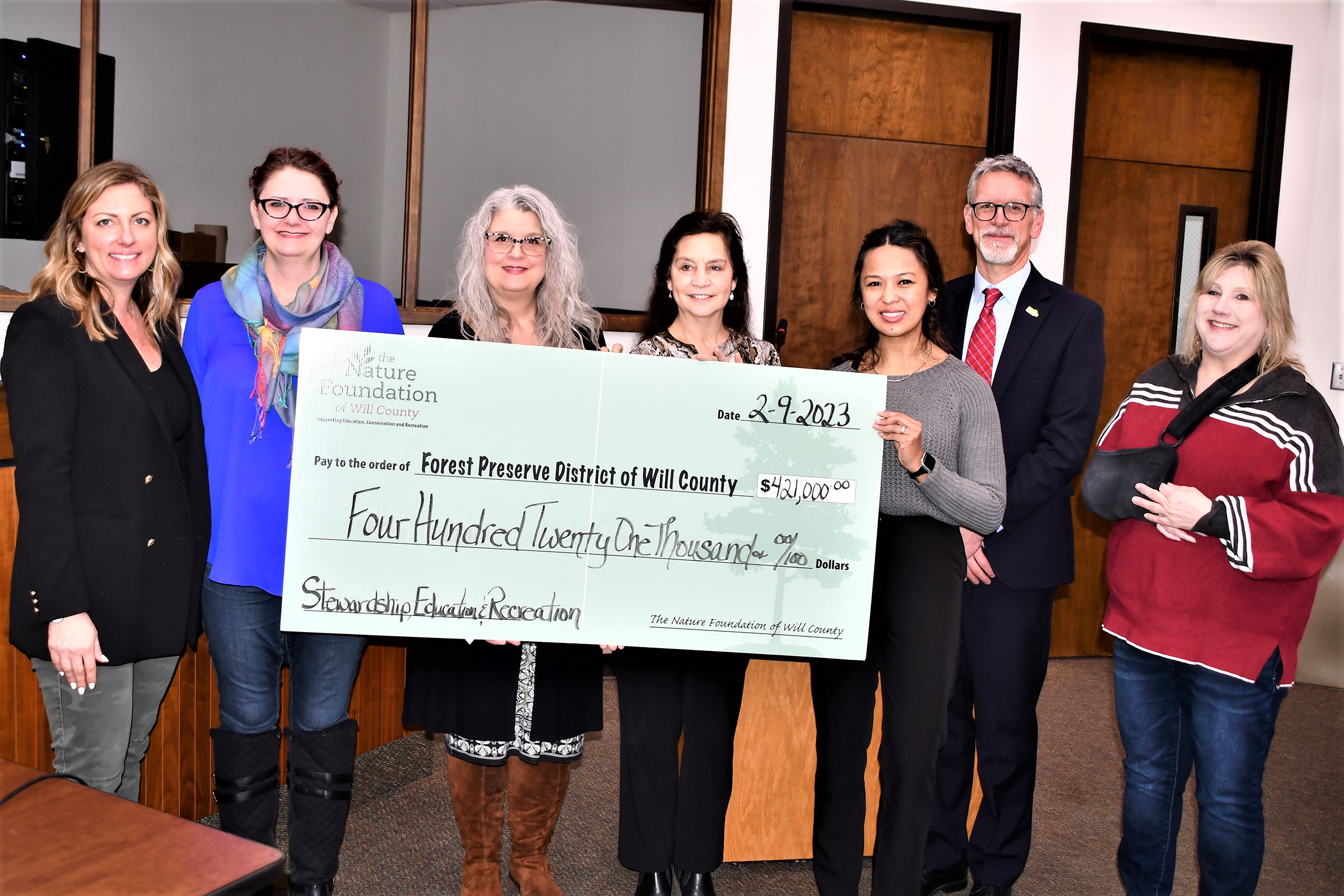Photo cutline: Nature Foundation of Will County representatives present a donation check at the Feb. 9 Forest Preserve District of Will County Board of Commissioners meeting. Pictured from left to right are Foundation Chairperson Ragan Pattison, Forest Preserve Board President Meta Mueller, Foundation Executive Director Cynthia Harn, Foundation Directors and Forest Preserve Commissioners Julie Berkowicz and Elnalyn Costa, Forest Preserve Executive Director Ralph Schultz and Forest Preserve Board Vice President Annette Parker. (Forest Preserve photo | Glenn P. Knoblock)