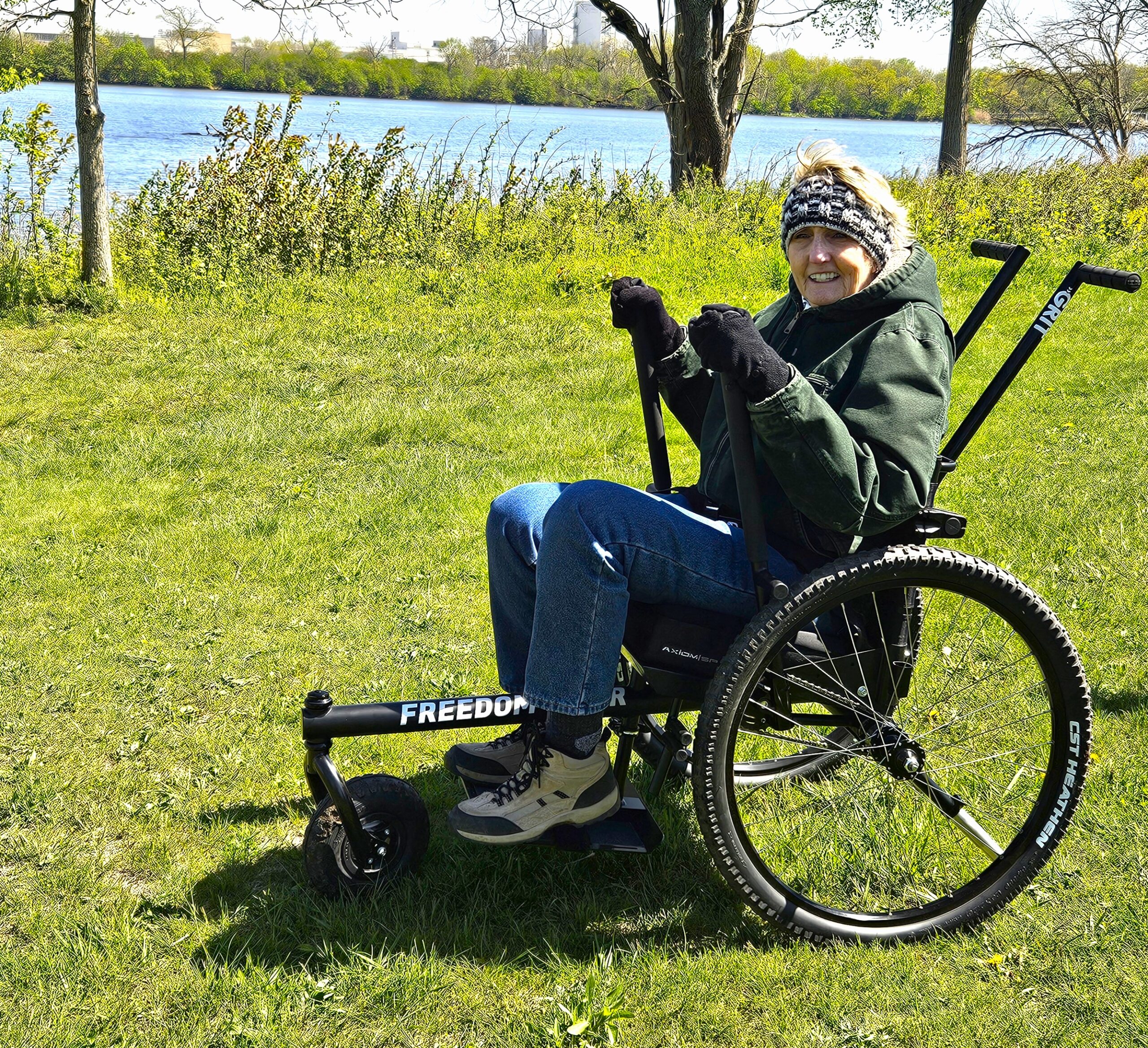 Kim Kosmatka of Mokena was the first person to test the new GRIT Freedom Chair at the Forest Preserve District of Will County’s Four Rivers Environmental Education Center in Channahon. She said she loved that she could travel over grass, roots and mud and feel secure while doing so. The wheelchair is available for public use at no cost. (Forest Preserve photo by Cindy Cain)