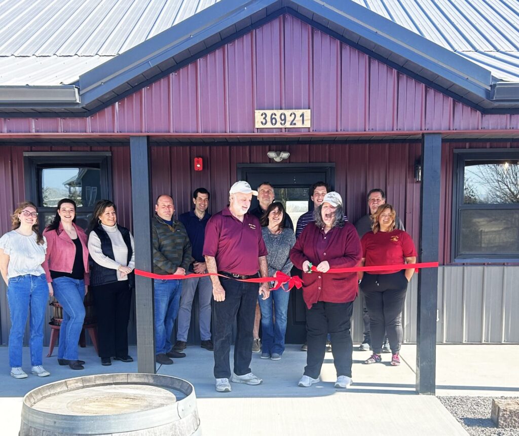 Mistiepic25 Mistie Hill Vineyard owners, Rich and Debbie Strylowski cutting the ribbon at the grand opening of their tasting room in Custer Park.