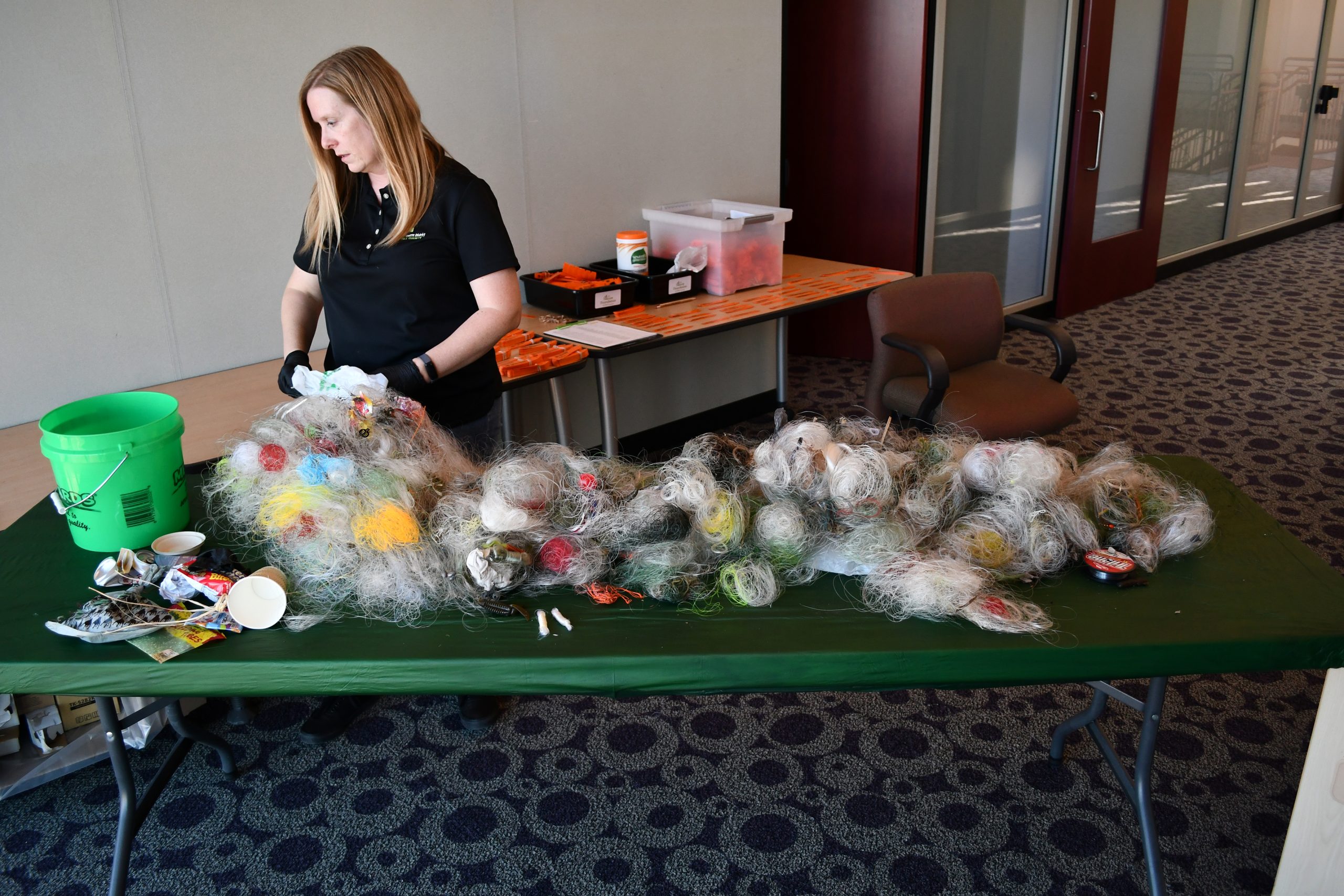 Jen Guest, recreation coordinator for the Forest Preserve District of Will County, picks through fishing line that anglers placed in monofilament recycling containers last year instead of discarding it in the water or environment where it could have harmed wildlife. The fishing line has been sorted and shipped to a recycling center where it will be made into new products.