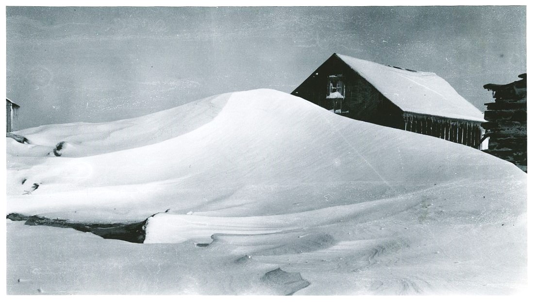 Tired of the heat? Maybe this will help. Here's a shot of the Seggebruch Farm with the hog shed in the background, under a pile and a half of snow. Ahhhhhhh!