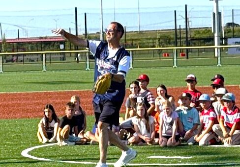 New Lenox Mayor Tim Baldermann throws out the first pitch to his Dad, Al, to open the festivities for the grand opening of the village's 100-acre Wintrust Crossroads sports complex at Interstate 355 just north of Interstate 80. (Photo by Stephanie Irvine)