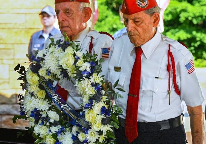 Korean War veteran Jack Gleason, left, and Korean War-era veteran George Anthos deliver the commemoration wreath at the June 24 ceremony commemorating the 75th anniversary of the beginning of the Korean War. (Photo by Stephanie Irvine)