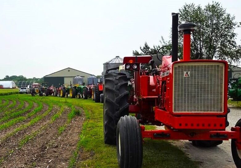 Thirty tractor drivers and 10 riders chugged along a 41-mile ride through the Will County countryside June 7 as part of the annual Vintage Tractor Ride sponsored by the Will County Threshermen's Association. The route began at the WCTA Show-grounds at Spiess Farm in Manhattan, and with a Will County Sheriff's Police escort, traveled to the Steve Issert Farm in Wilmington for lunch prepared by Brian Kestel and Brian Hennings before heading back. Right, Wiley Sawyer traveled from Waterman on a JD 630 for the event. Below, the group shows a good time was had by all. (Photos by Pam Robbins)
