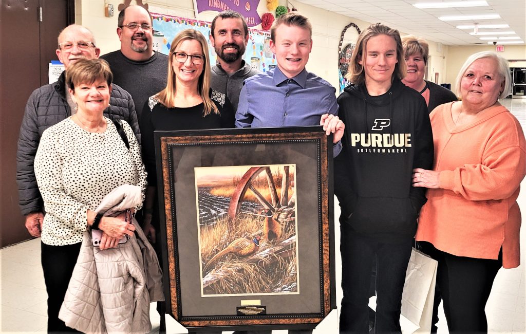 bendeutsche23 Ben Deutsche was the key in getting a new agriculture program started at the Crete\Monee High School. He had worked hard on this project with the school board, administration, family and Luke Allen, regional Ag Facilitating Coordinator. In appreciation, the Will County Farm Bureau presented him with a painting. Ben holds the award, accompanied by his family, from left, Nancy Chittenden, Todd Chittenden, Darren Deutsche, Kelly Deutsche, Kyle Deutsche, Ben Deutsche, Jack Deutsche, Amy Deutsche and Mary Ann Deutsche.