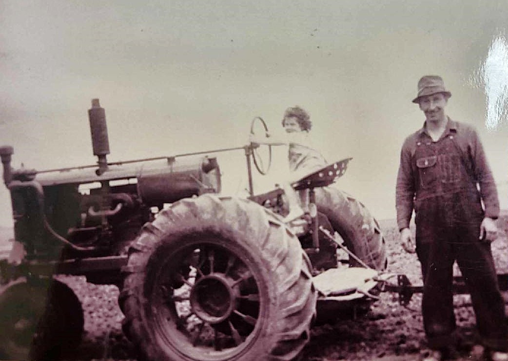 Clarence Sangmeister obviously was very proud of daughter Jeanette for all she could do, including drive the tractor!