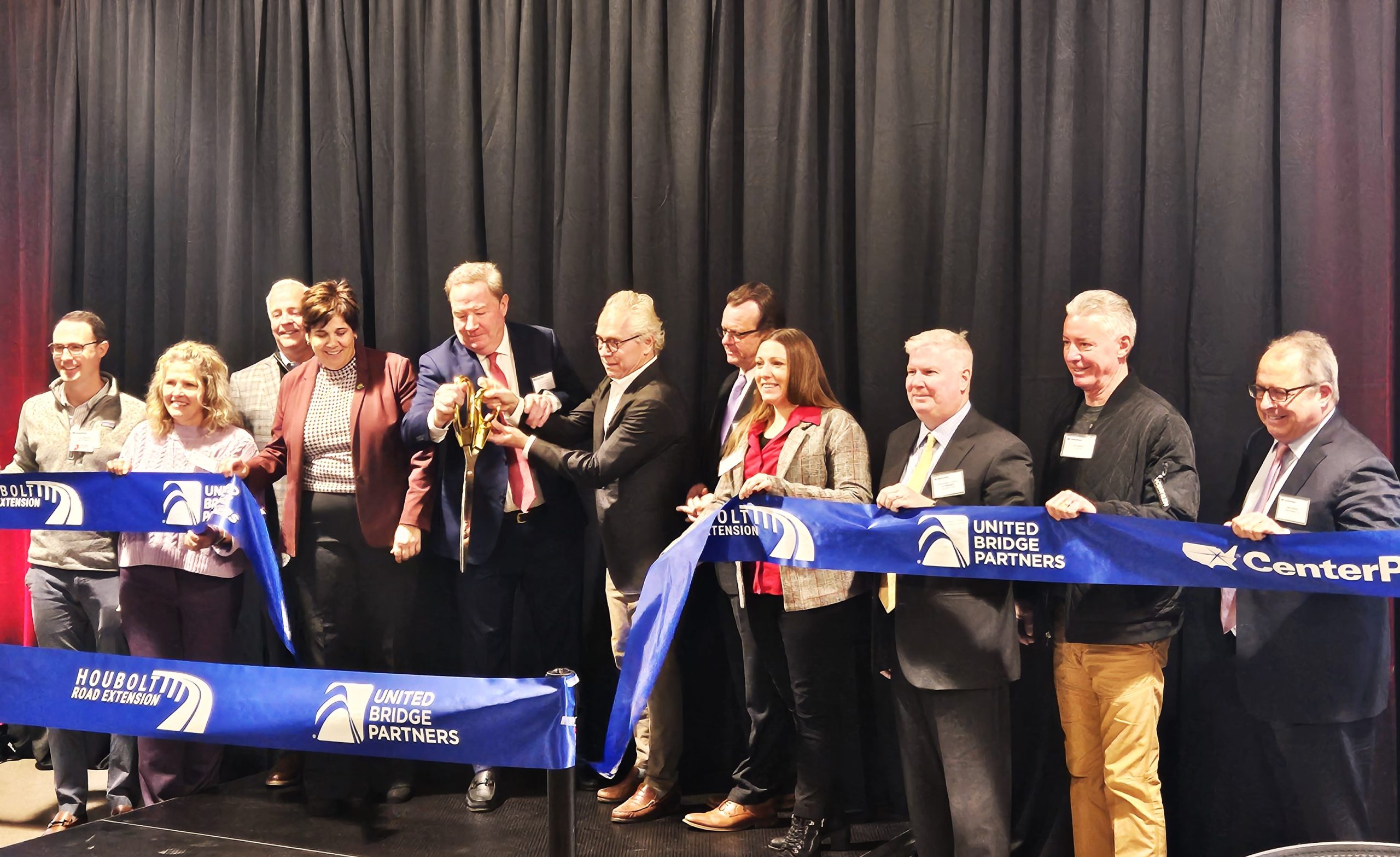Representatives of CenterPoint Properties and United Bridge Partners celebrate the completion of the new Houbolt Road Corridor, which allows trucks to enter the intermodal yards to the south with a new $14o million .4-mile bridge.