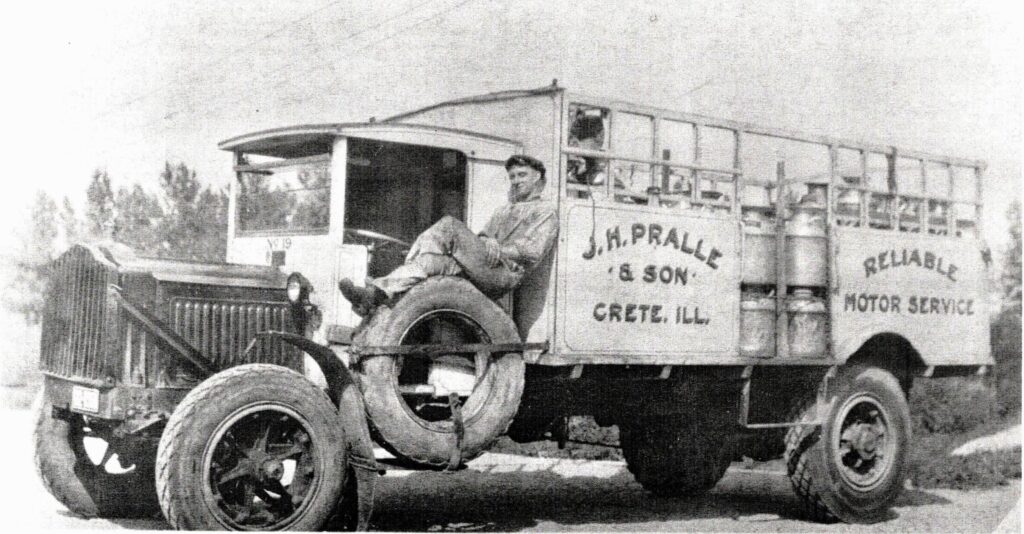This driver takes a break after picking up cans of milk from area farms and bringing them to the Pralle Milk plant in Crete. There, the milk was dumped into a large vat, then loaded into a large truck and brought to Capitol Dairy in Chicago where it was bottled for delivery to home customers.
