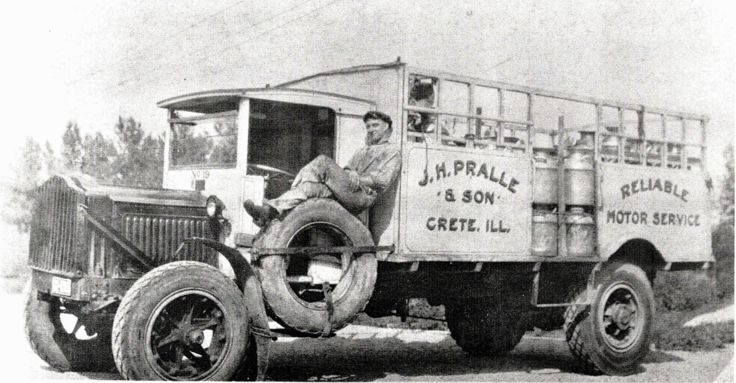This driver takes a break after picking up cans of milk from area farms and bringing them to the Pralle Milk plant in Crete. There, the milk was dumped into a large vat, then loaded into a large truck and brought to Capitol Dairy in Chicago where it was bottled for delivery to home customers.