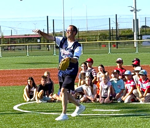 New Lenox Mayor Tim Baldermann throws out the first pitch to his Dad, Al, to open the festivities for the grand opening of the village's 100-acre Wintrust Crossroads sports complex at Interstate 355 just north of Interstate 80. (Photo by Stephanie Irvine)