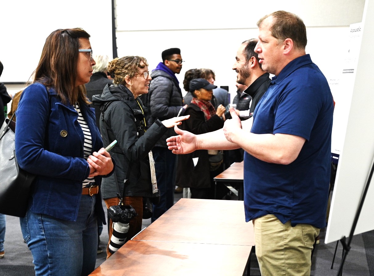Manhattan resident Andrea Baumhardt talks to a representative from one of the companies poised to answer questions at the Joliet Technology Center open house February 12 at the Joliet Junior College Main Campus. (Photo by Stephanie Irvine)