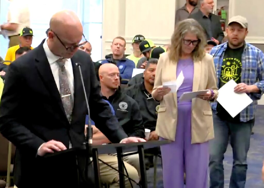 Shorewood Mayor Clarence Debold comments at the April 16 Will County Board meeting on the solar farm near the village that a judge ordered the County Board to approve. Waiting her turn is Channahon Mayor Missey Schumacher.