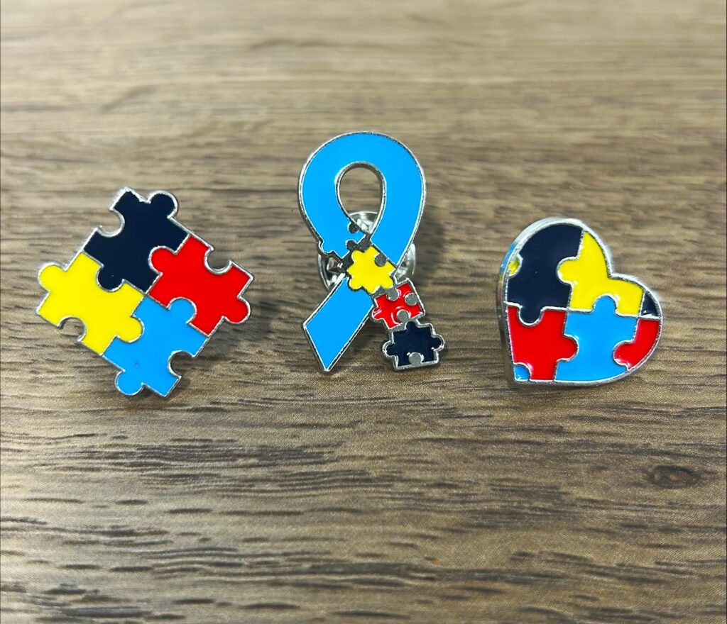 elautism-2 Three pins are offered for collection during the month-long event.
