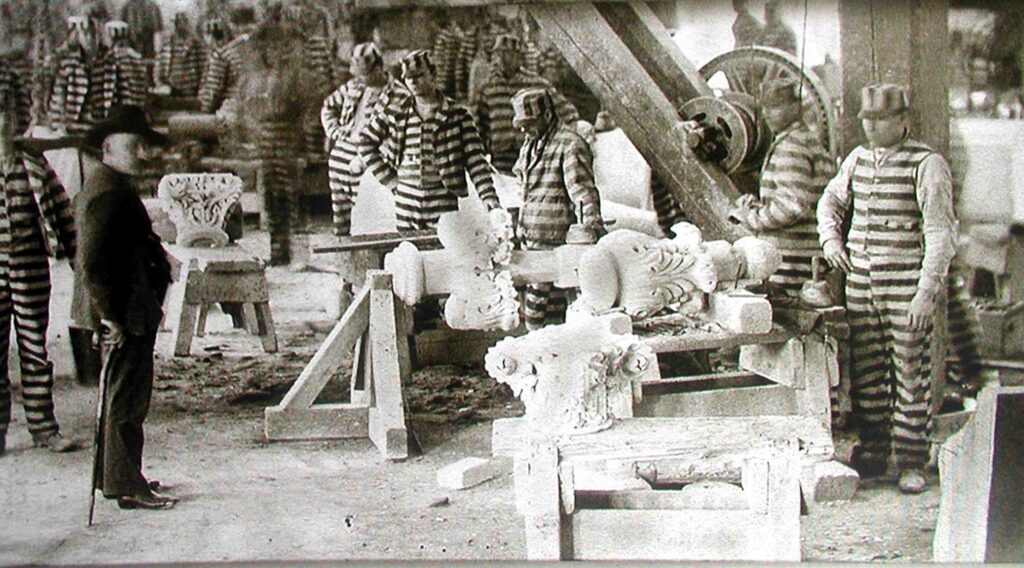 granite shop (1) In 1877, the convicts at the Joliet Penitentiary were being used as free laborers in the quarries. Men with families to feed had been put out of work.