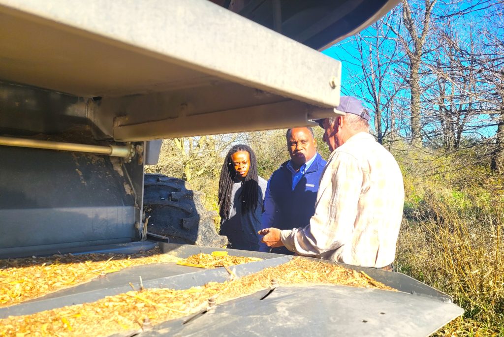 U.S. Rep. Jonathan Jackson, center, and staff visited the Rick Johnson farm recently to see first-hand how farmers combine crops in the fall. The Congressman even combined a few rows himself.