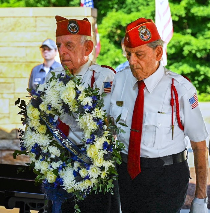 Korean War veteran Jack Gleason, left, and Korean War-era veteran George Anthos deliver the commemoration wreath at the June 24 ceremony commemorating the 75th anniversary of the beginning of the Korean War. (Photo by Stephanie Irvine)