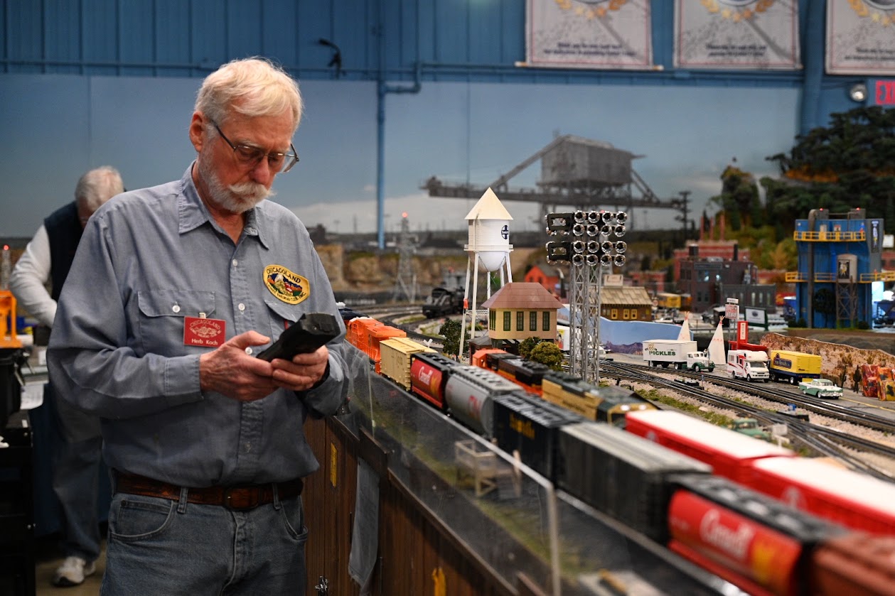 Herb Koch, president of the New Lenox-based Chicagoland Lionel Railroad Club, prepares his train to run one of the many tracks at the club's headquarters. (Photo by Stephanie Irvine)