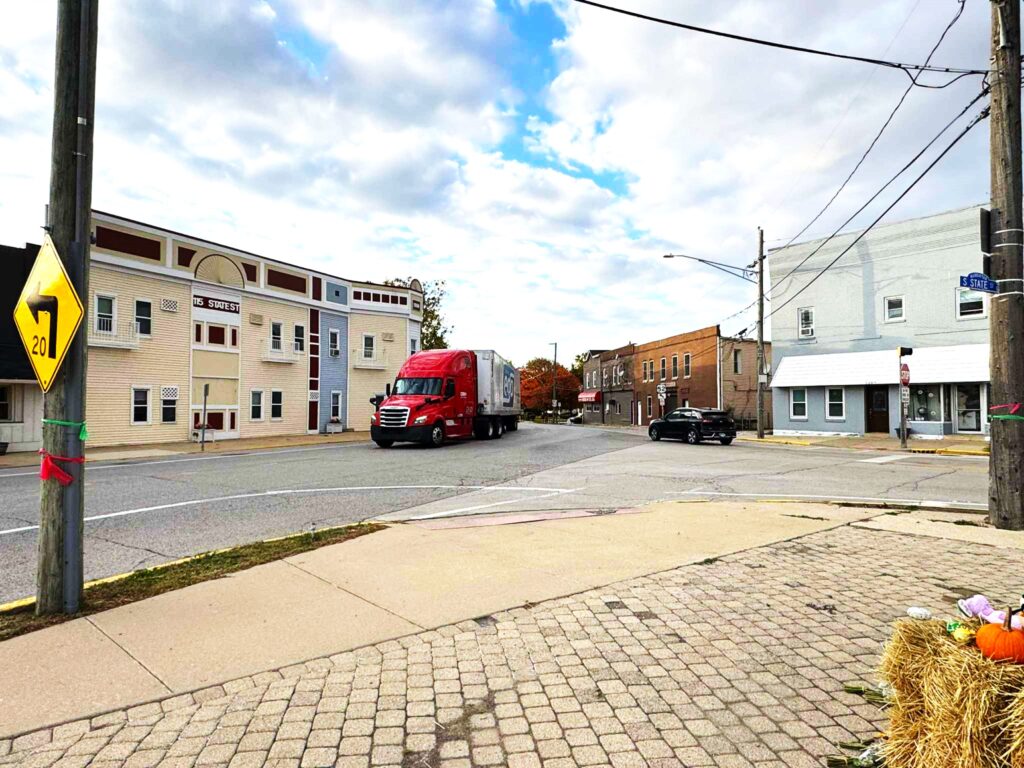 U.S. 52 is a state highway and designated truck route, but the narrow curve as it enters Manhattan's downtown makes it difficult for trucks, especially for those whose drivers ignore the village's 65-foot limit. (Photo by Ron Adamski)
