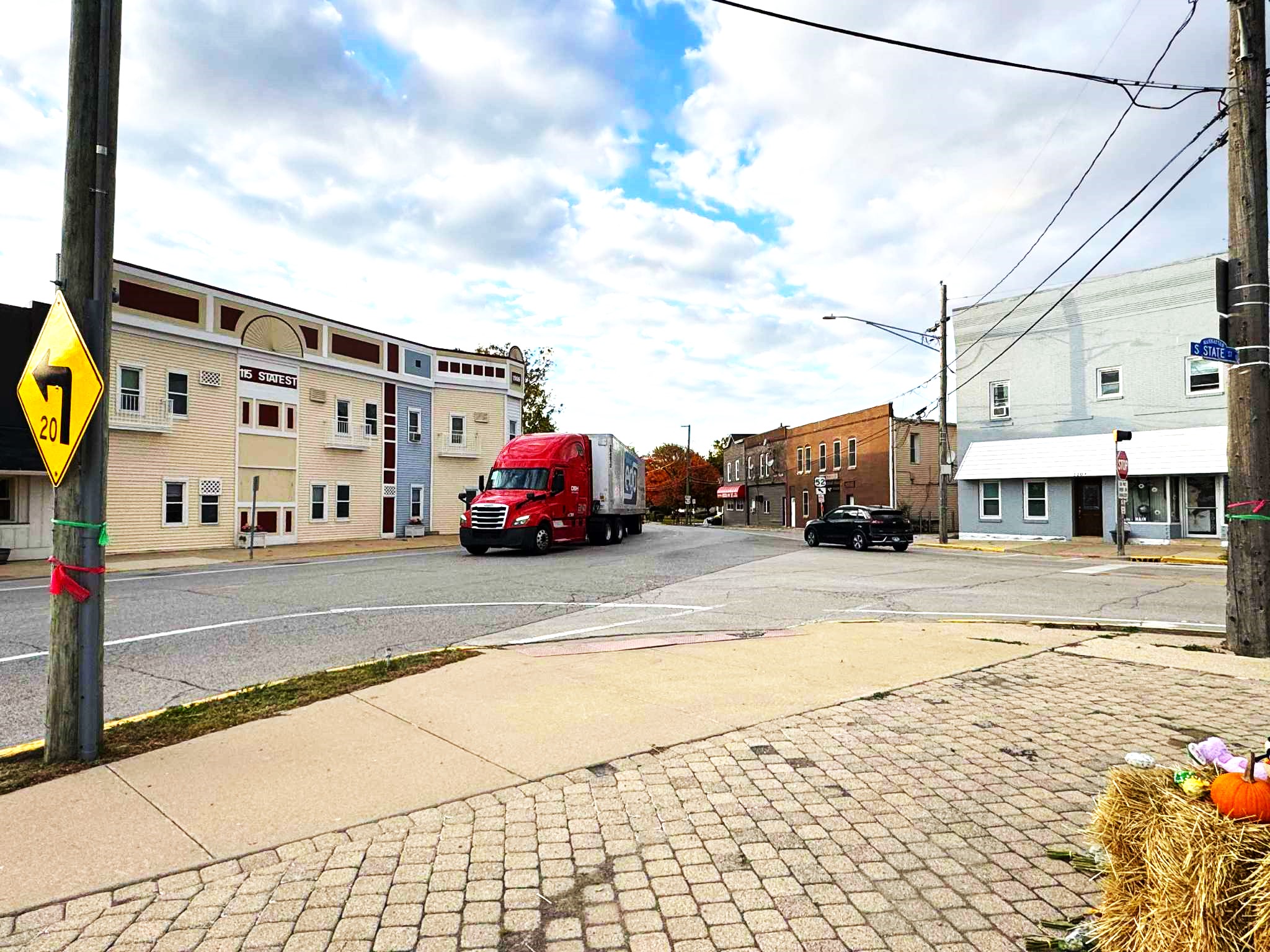 U.S. 52 is a state highway and designated truck route, but the narrow curve as it enters Manhattan's downtown makes it difficult for trucks, especially for those whose drivers ignore the village's 65-foot limit. (Photo by Ron Adamski)