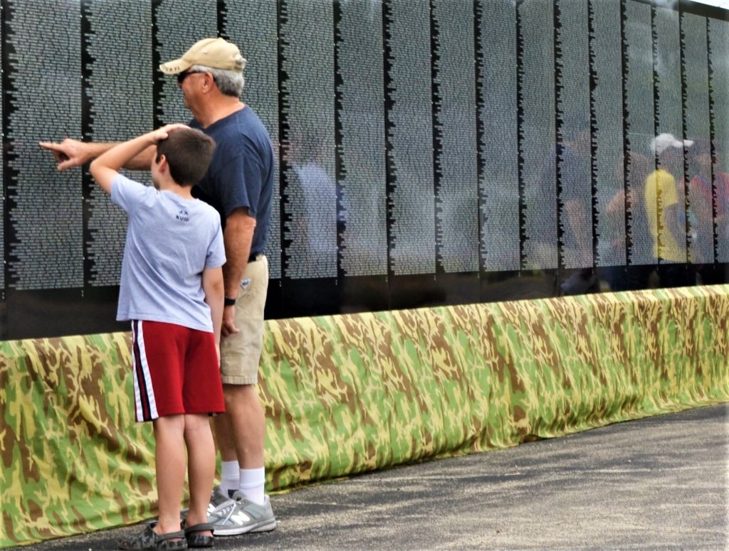 You're never too young to show appreciation for those who gave their lives for our freedom. Visitors of all ages came from throughout the area to pay their respects at the Vietnam Moving Wall that came to Manhattan during the Fourth of July holiday weekend. (Photo by Karen Haave)