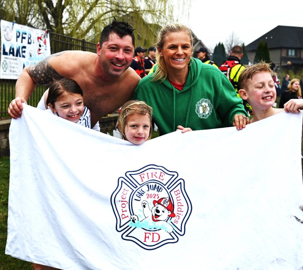 manplunge25steph-1 Jimmy and Maripat Janchenko pose for a picture with their kids, from left, Makinley, Finley, and Easton, during the Manhattan Fire Buddies' first Polar Plunge fundraiser on March 29. The event raised about $25,000 to help kids stricken with severe illnesses. (Photo by Stephanie Irvine)