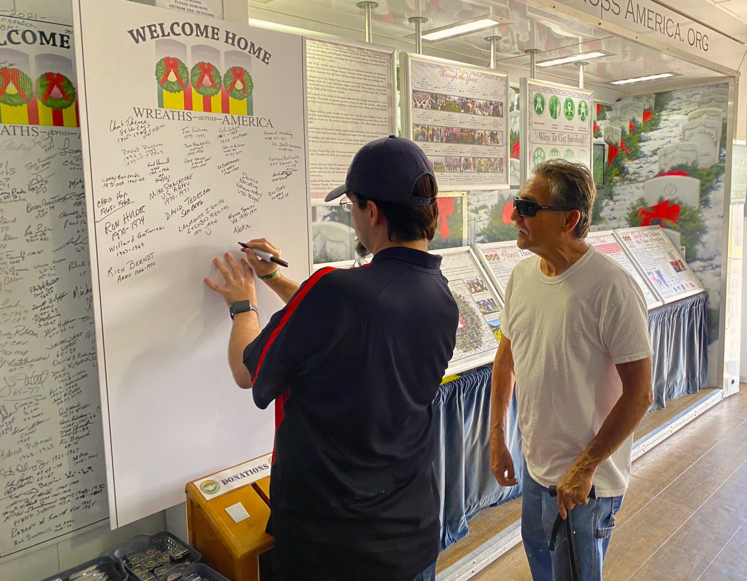 WAA Driver Ambassador Robert Easley assists Vietnam veteran Al Gutierrez with adding Gutierrez’s name to the Vietnam Veterans appreciation wall. (Photo by Stephanie Irvine)