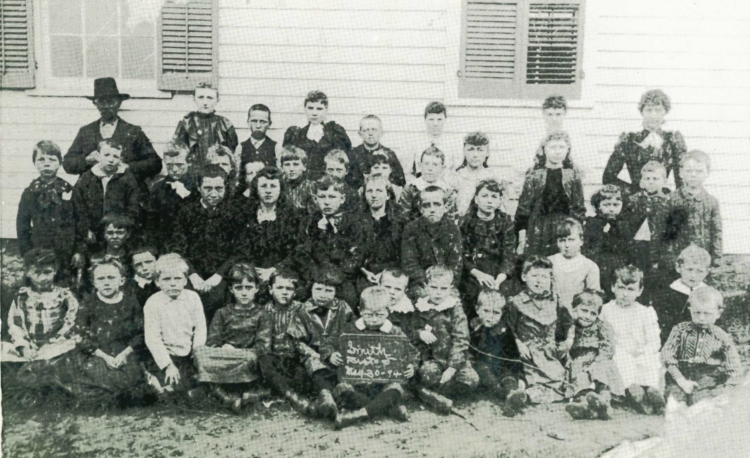 Here's an oldie. The following are the persons appearing in this photo in front of the Smith District School, May 30, 1894. The school was situated on South Chicago Street at the southwest corner of what is now called Millsdale Road, a mile south of what is now called Schweitzer Road. An original of this photograph is in the possession of William F. Korst of Joliet, who was kind enough to identify the people in this photo. First row, from left, Elizabeth M. Wilhelmi; Annie Arnold; William Steffes; Ernest Eaton; Jacob Steffes; Nellie Attaway; Arthur Steffes; Katherine Eich; Peter Madsen; Edward and Evan Kirk, twins; George Eich; R. Eich; Mae Attaway; Susan Attaway; Mayme Wilhelmi; Ed­ward(?) Block; William Arnold; Middle Row, from left, Henry Ley; Raymond Stephen; Frank Eich; John Eaton; An­nie Madsen;·Clarence Effner; Mary Ley; Anne Korst; John J. Wilhelmi; Arthur Madsen; Adelaide Ley; Edith Kirk; Alfred Attaway; Frank Noel; Katherine Wilhelmi; Amelia Steffes; Maude Miller; Rose Miller; William F. Korst; Edward G. Korst; Back row, from left, Louis Madsen (father of the Madsen children); Edith Gibler; Sam Attaway; Maude Young; Neil Madsen; Virginia Kirk; Irene Kirk; Sarah Smith, teacher.