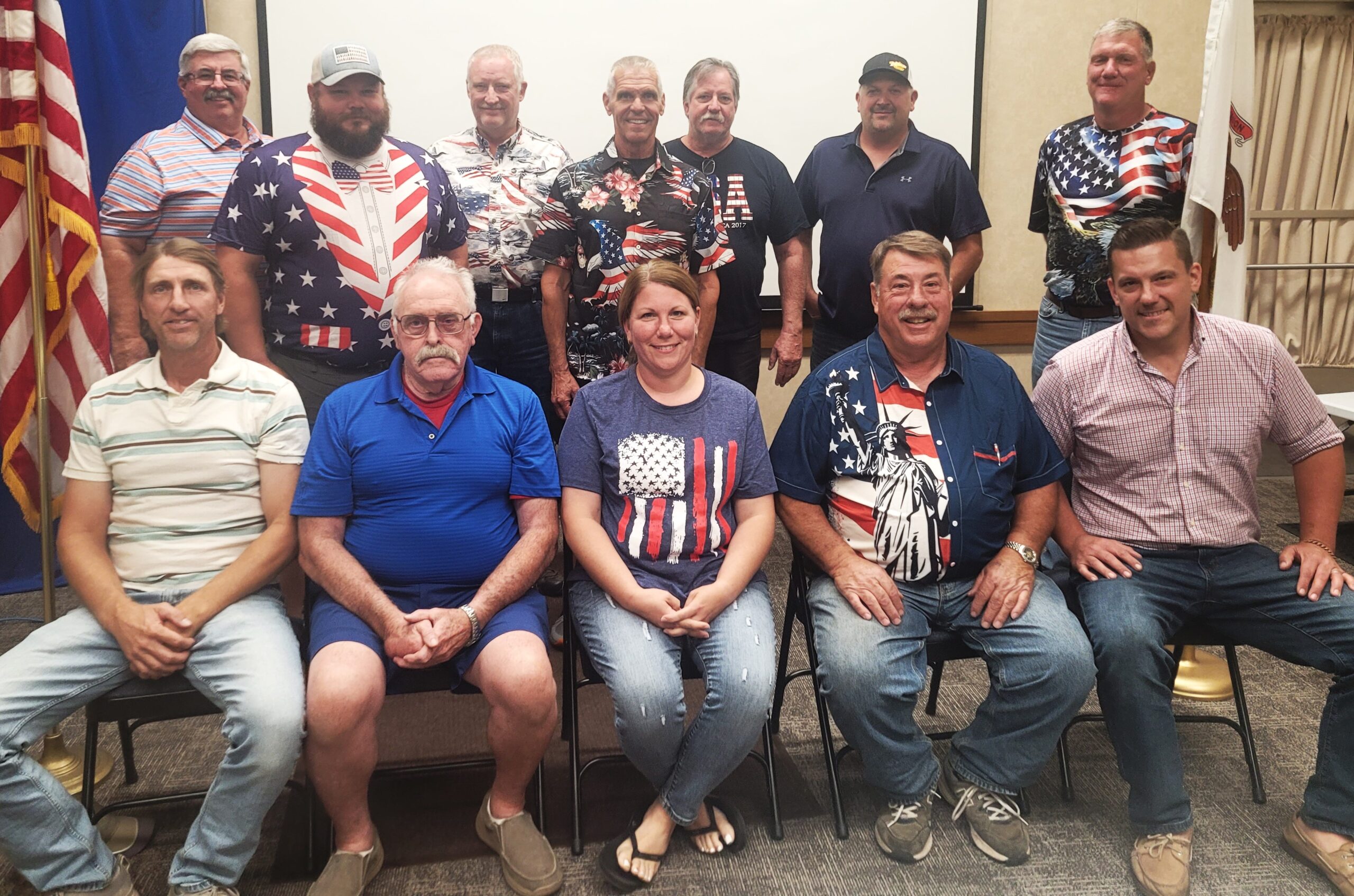 It was Patriotic Shirt Night at the August Board meeting: Front row, from left, Mike Newbrough, Pat McDonald, Kelly Reus, Steve Warrick, Brad Metzger. Back row, from left, George Beutel, Mike Robbins, John Andermann, Dave Kestel, Gordon McCoy, Craig Bettenhausen and Don Mulderink.