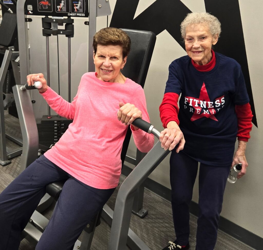 Loretta Sartore, right, encourages friend Diana Szalkus atFitness Premier Manhattan. Sartore, who will turn 90 on February 16, hits the gym after walking 4 miles each morning. (Photo provided)