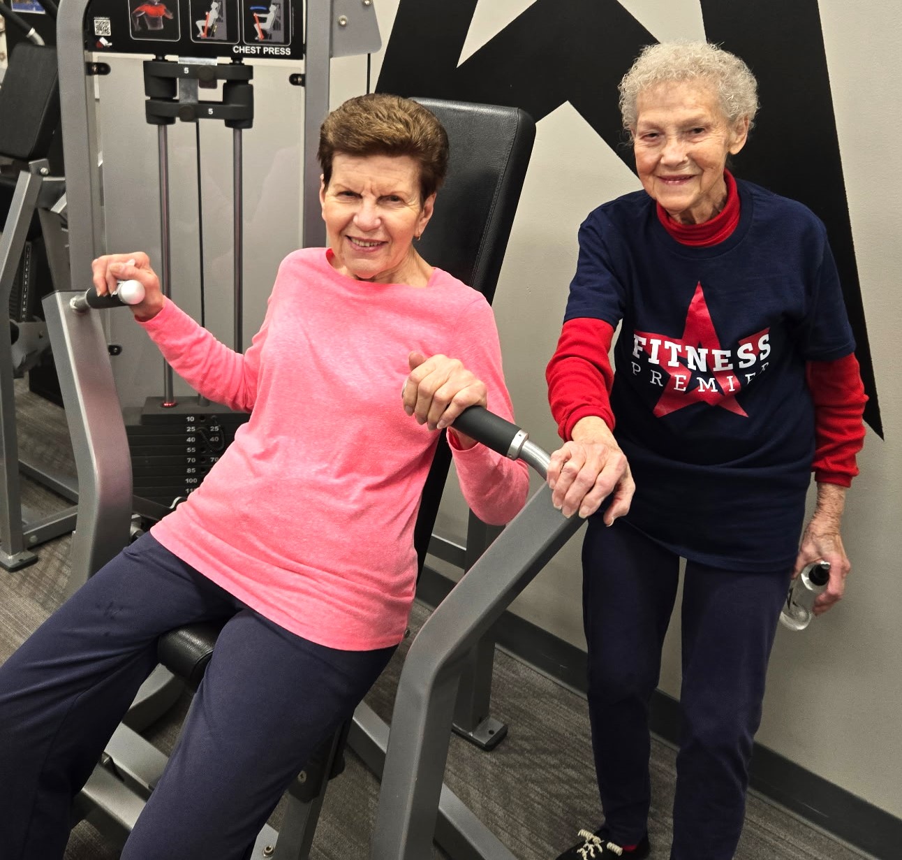 Loretta Sartore, right, encourages friend Diana Szalkus atFitness Premier Manhattan. Sartore, who will turn 90 on February 16, hits the gym after walking 4 miles each morning. (Photo provided)