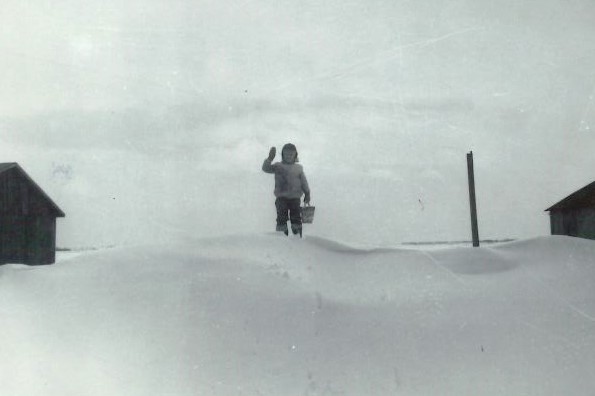 You think we got hit with snow? Here's Steve Seggebruch standing lonely on a drift on the farm in Crete in 1961.