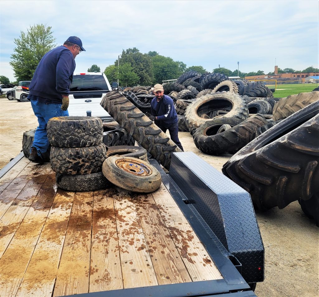 Darren and Kyle Deutsche work to unload their trailer of tires during the used tire collection sponsored by the Will County Land Use Department September 16 at the Will County Fairgrounds in Peotone. More than 6,500 tires, including 1,700 farm tires, were collected for separation of metal and rubber pieces and recycled for various uses.