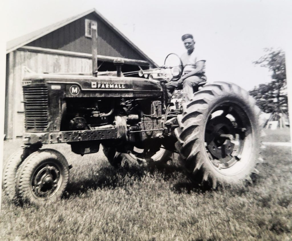 Raymond Tewes driving a brand new 1950 Farmall M tractor in Frankfort in 1950. The tractor is now owned by his nephew, Kurt Tewes.