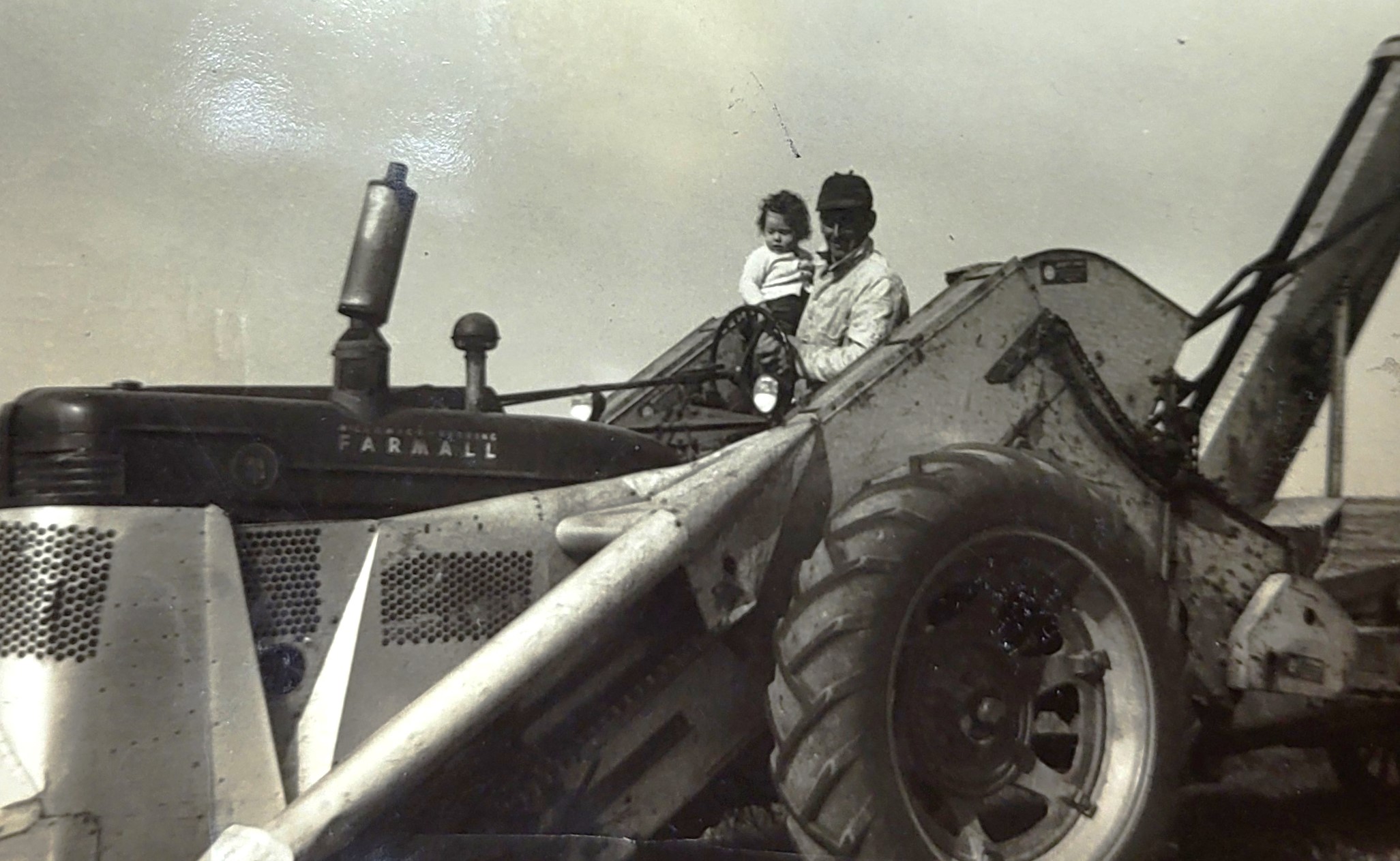 The Brandau family shares this photo of Clarence Sangmeister holding Jeanette (Sangmeister) Brandau on their Uncle Erwin’s Farmall Picker. Good times.