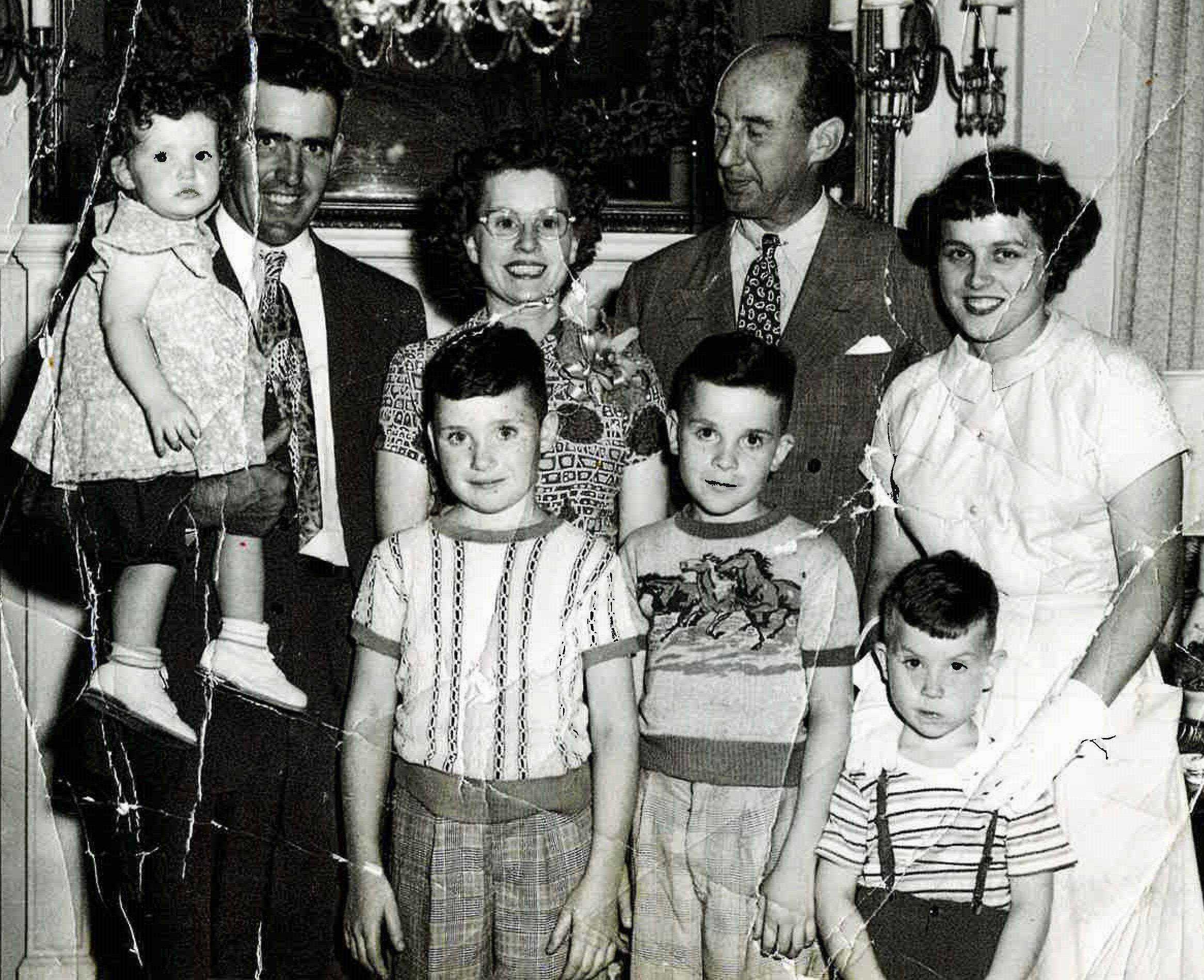 In 1951, the Eugene and MaryKay Gallagher family were voted Typical Farm Family of Illinois. They lived in Manhattan Township, where they farmed 440 acres of corn, soybeans, oats and hay. They also raised Hereford cattle, Brow Swiss milk cows, Chester White hogs and 200 White Rock laying hens. Pictured in back row is Eugene holding youngest daughter Jeanene, MaryKay, Governor Adlai Stevenson and foster daughter Myrtle Mitchell. (Myrtle came for the summer from Guardian Angel Home in Joliet to help when Ricky was born. She then never left the family after her arrival in Summer of 1946 and became a sibling to all the Gallagher children) Front row Kenny, David and Ricky Gallagher. They were honored by Governor Stevenson at the State Fair in Springfield in 1951.