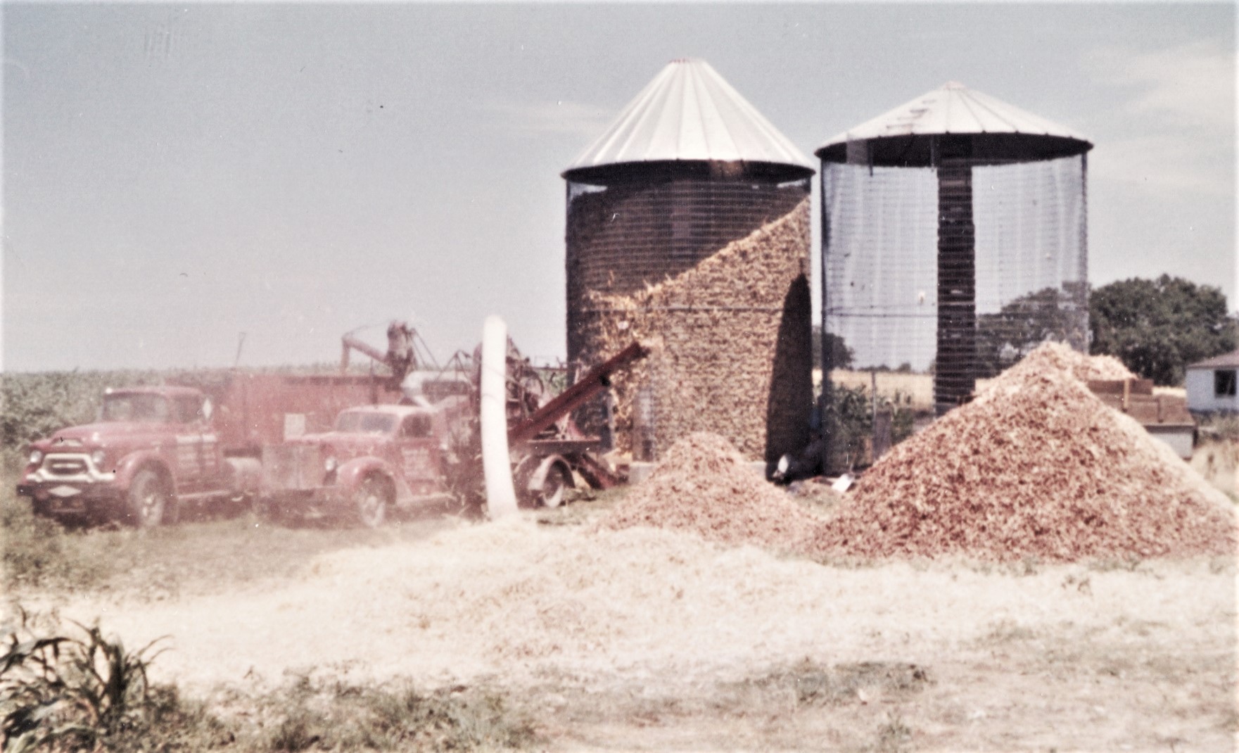 John and David Kiefner share this photo of a whole lot a shellin' goin' on in July 1961 on the former Kiefner farm where the on-ramp for westbound I-80 from Houbolt Road now is, about 200 feet south of the current Heroes West restaurant. Most likely, that's George Schroeder's sheller and Art Hiller's truck.