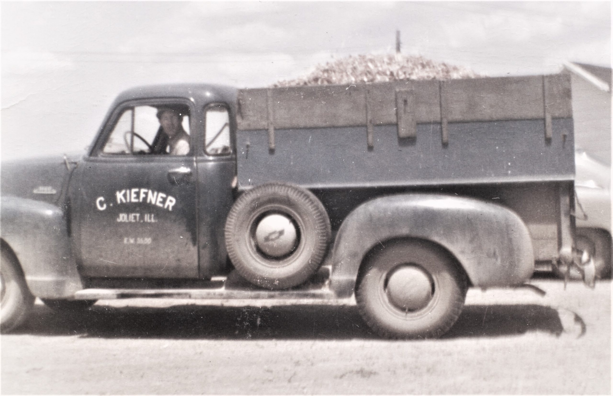 Robert Kiefner in Conrad Kiefner's truck hauling a load of corn cobs in the 1950s. Think he's on his way to do some patching work at the Corn Palace in Mitchell, South Dakota?