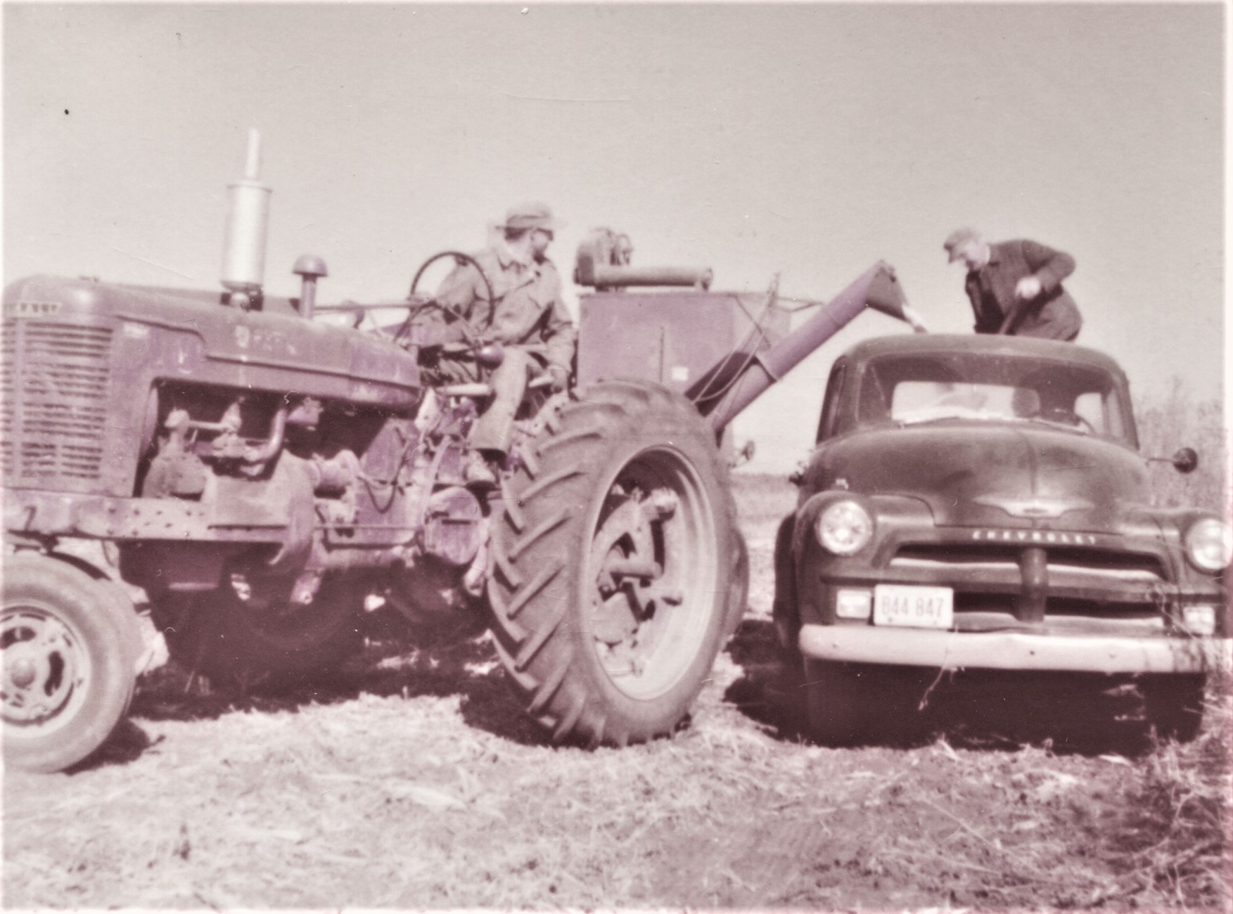 Soybean Harvest October 1958 on the Kiefner Farm, Robert on the tractor, Conrad on the truck. The farm was along what possibly was known then as Reardon Road, now called Houbolt Road. Conrad was the father of Robert, who was the father of John Kiefner. The farm lost a couple acres in the 1960s when Interstate 80 was built. With the highway being only about 150 feet from the house, all remnants of it were destroyed when the Houbolt road interchange was built in 1991.