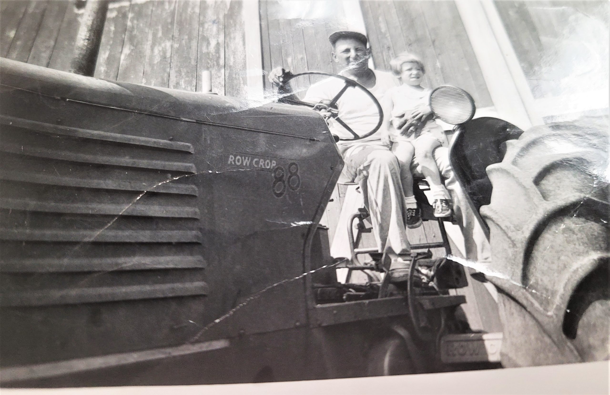 Eugene Wilhelmi with daughter Marleen in 1955 on the Wilhelmi Farm in Elwood on the Row Crop 88 Oliver.