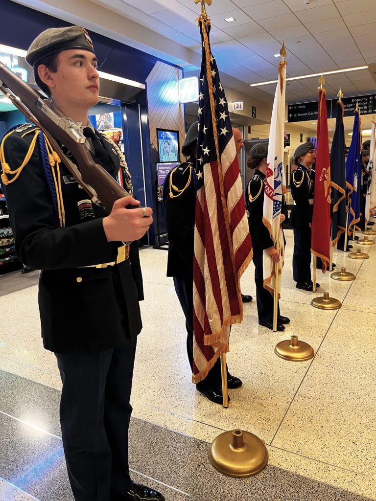 welcome25 Among the welcome home festivities for the returning 111 Vietnam Veterans aboard Honor Flight Chicago #121 was the Joliet Central Army ROTC, which included their nine-member presentation squadron and an additional 48 cadets. Under the direction of Major (Ret.) Phillip Jayko and MSG (Ret) Gary McClellan, presentation of colors was made during the opening ceremony and the service branch flags were presented for the US flag line walk through. As the veterans arrived to meet their friends and loved ones, the JROTC led the final segment of the Parade of Honor accompanied with patriotic music by the Frankfort Brass Band under the direction of Mike Orenic.(Submitted Photo)