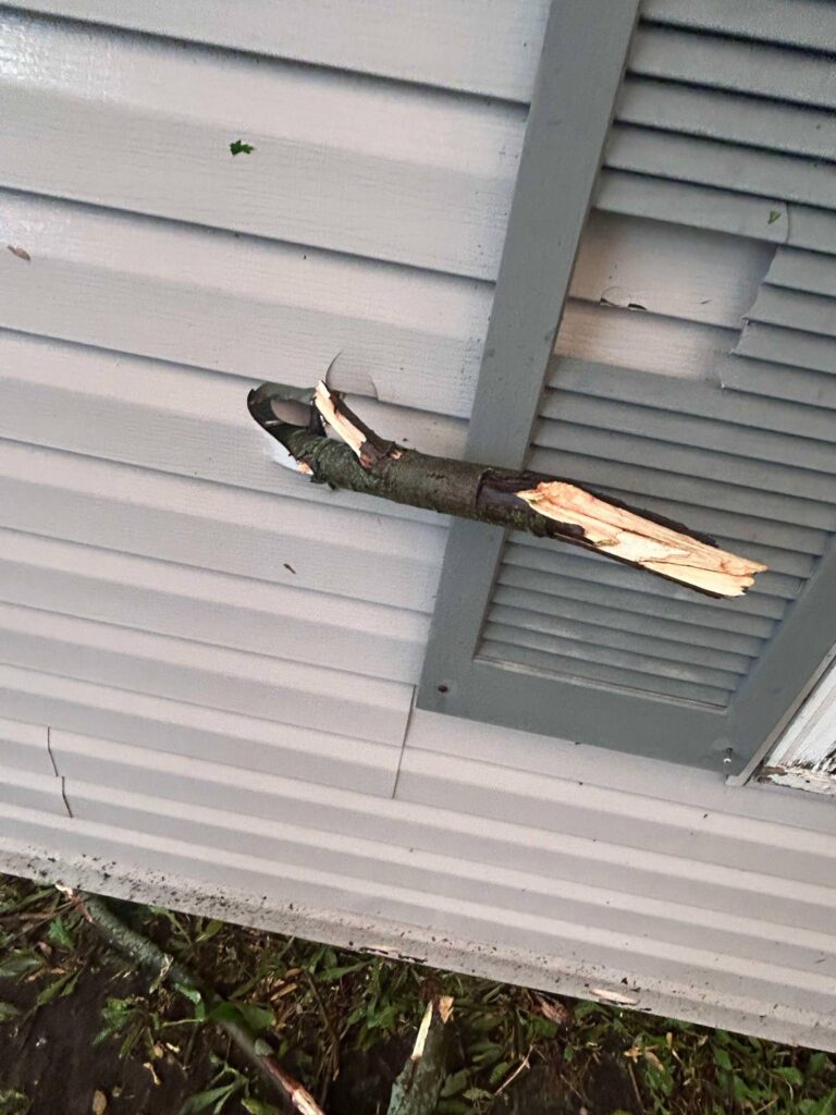 woodthroughmanhome25-2 Gary Anderson from unincorporated Manhattan shared these photos of damage to his home off Route 52 following the May 15 storms that hit southern Will County. Part of a branch from a nearby tree broke off and speared through the home's siding.
